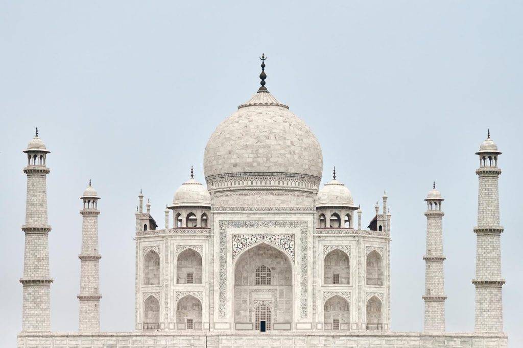 Taj Mahal white marble mausoleum landmark in Agra, Uttar Pradesh, India, beautiful ancient tomb building of Mughal architecture, popular touristic place with white marble exterior decorations